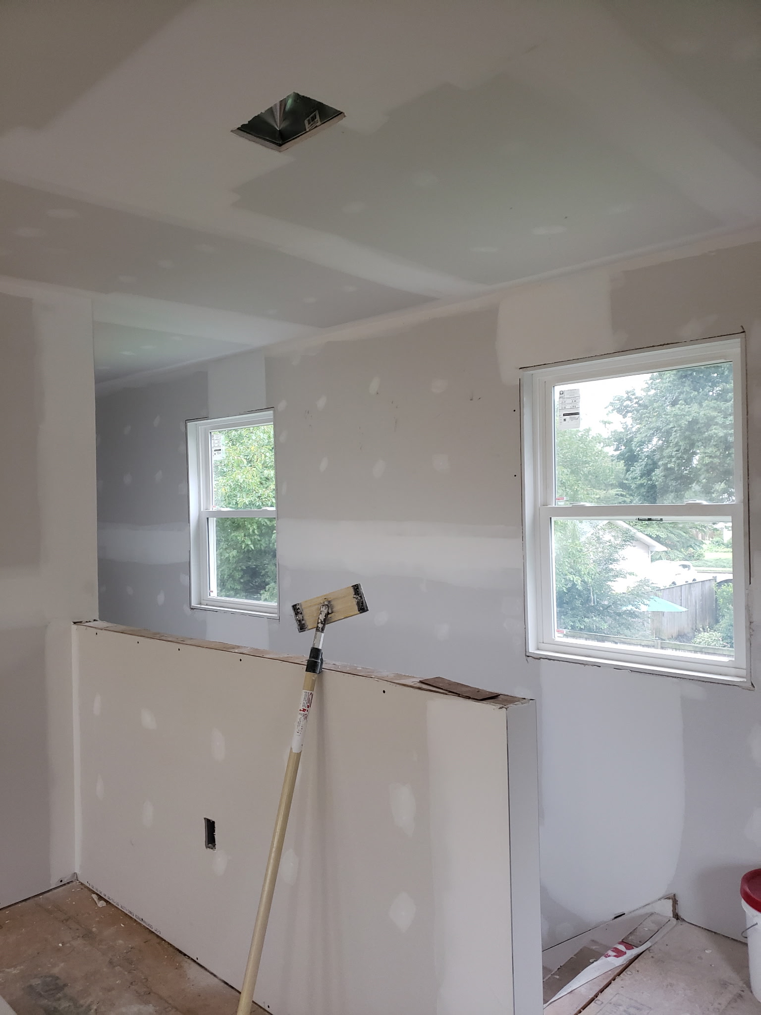 New drywall around windows with taped seams and joint compound