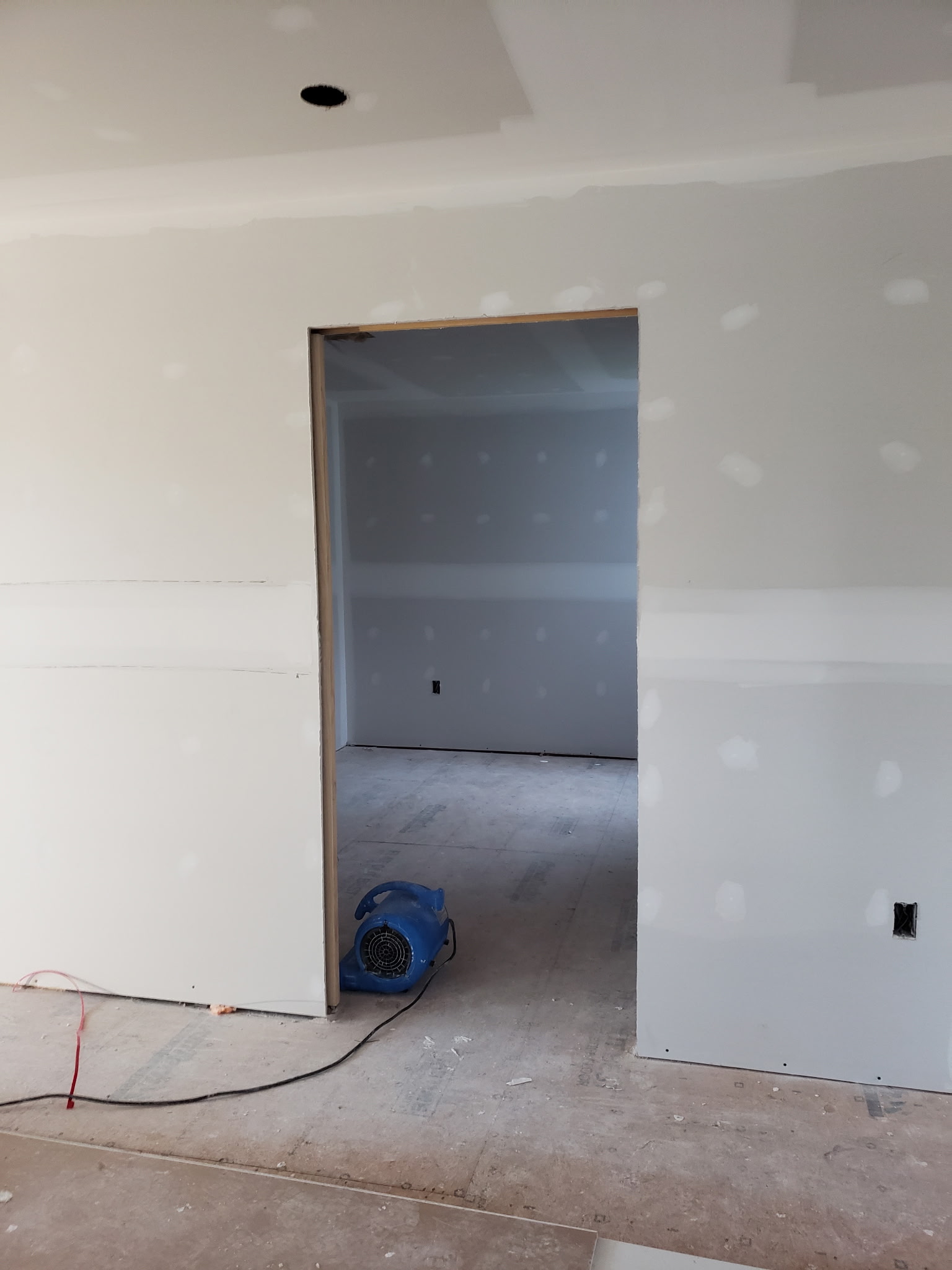 Drywall installation and finishing around an interior doorway