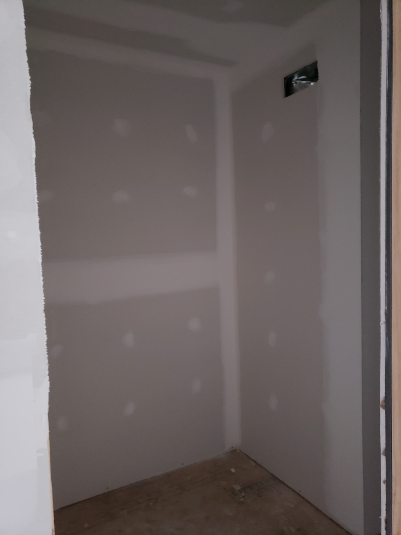 Small interior space with newly finished drywall seams and fasteners